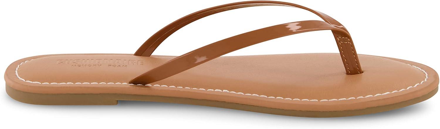 imageCUSHIONAIRE Womens Cora Flat Flip Flop Sandal with ComfortCognac Patent